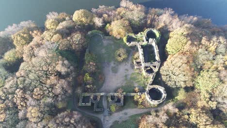 Liverpool-castle-replica-ruins-in-Autumn-Rivington-woodland-nature-reservoir-landscape-aerial-slow-birds-eye-rising