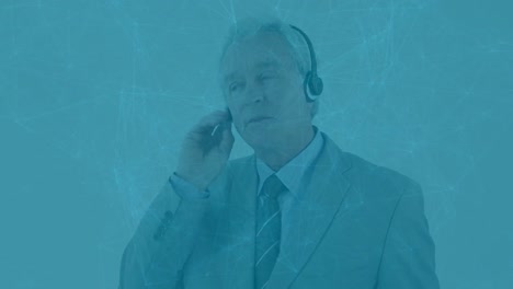 Animation-of-network-of-connections-over-caucasian-senior-businessman-talking-on-phone-headset