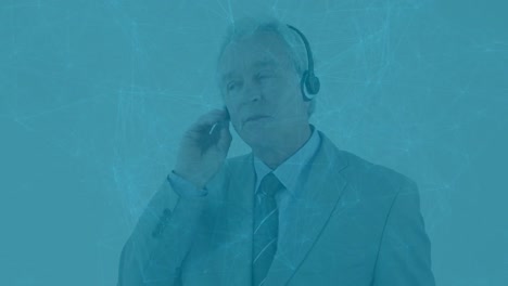 animation of network of connections over caucasian senior businessman talking on phone headset