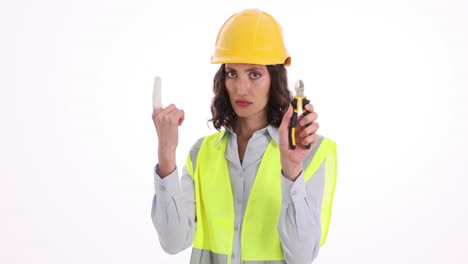 female construction worker with injured finger and pliers