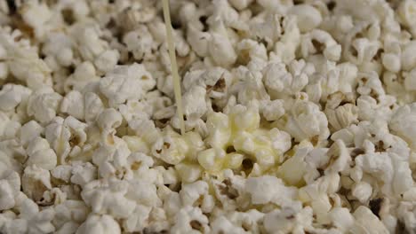 pouring butter on popcorn