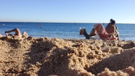 people are seen relaxing in the background on the edge of the beach enjoying the beauty of the ocean