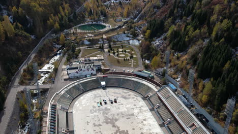 Aerial-view-rising-away-from-the-medeu-stadium,-sunny,-fall-day-in-Kazakhstan