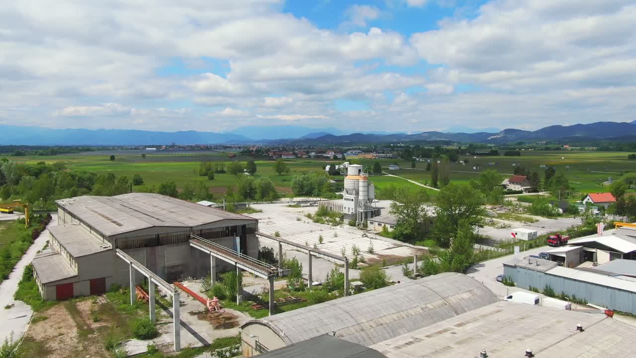 Aerial view of city outskirt with industry and mountain range near Celje Slovenia