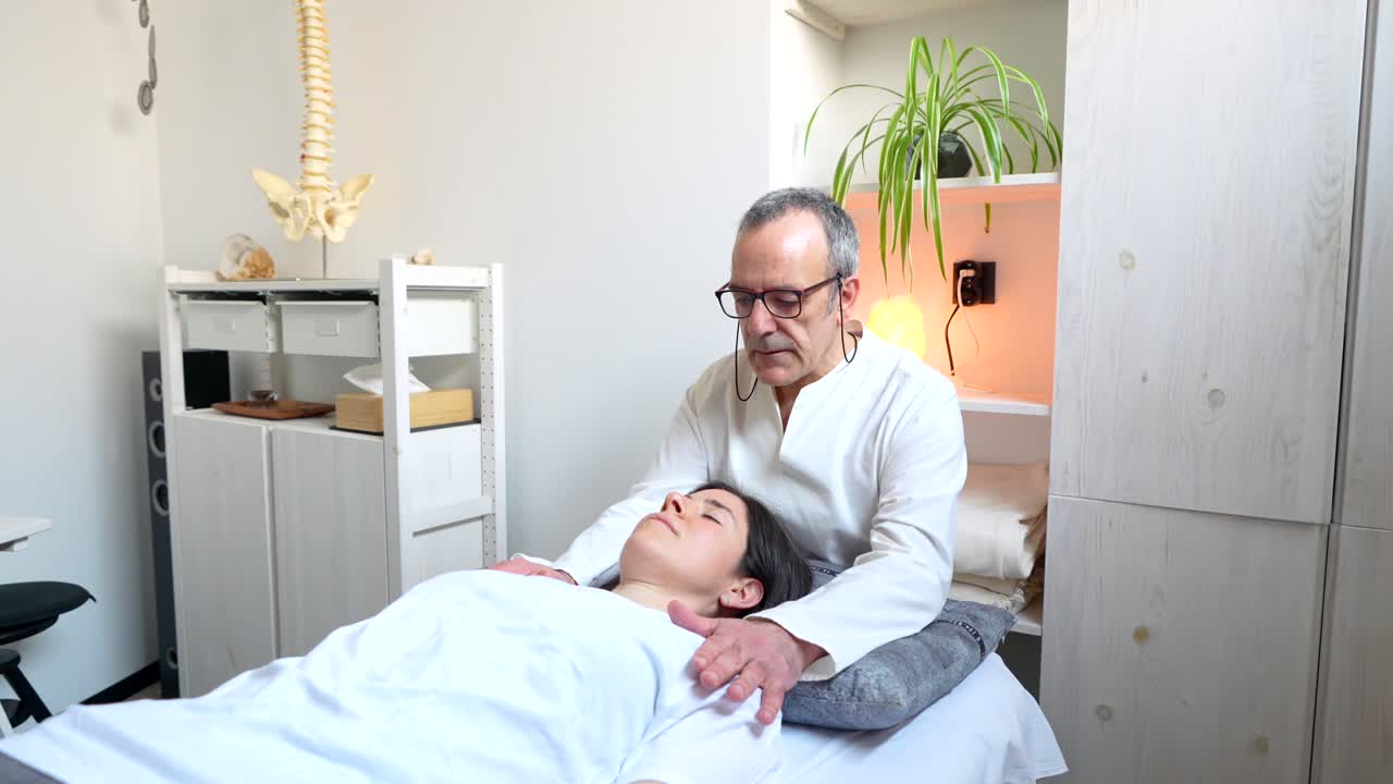 Chiropractor performing neck adjustment on a patient