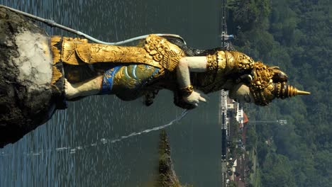 Vertical-static-shot-of-religious-hindu-statues-at-danau-batur-at-water-temple-on-bali-indonesia-in-slow-motion