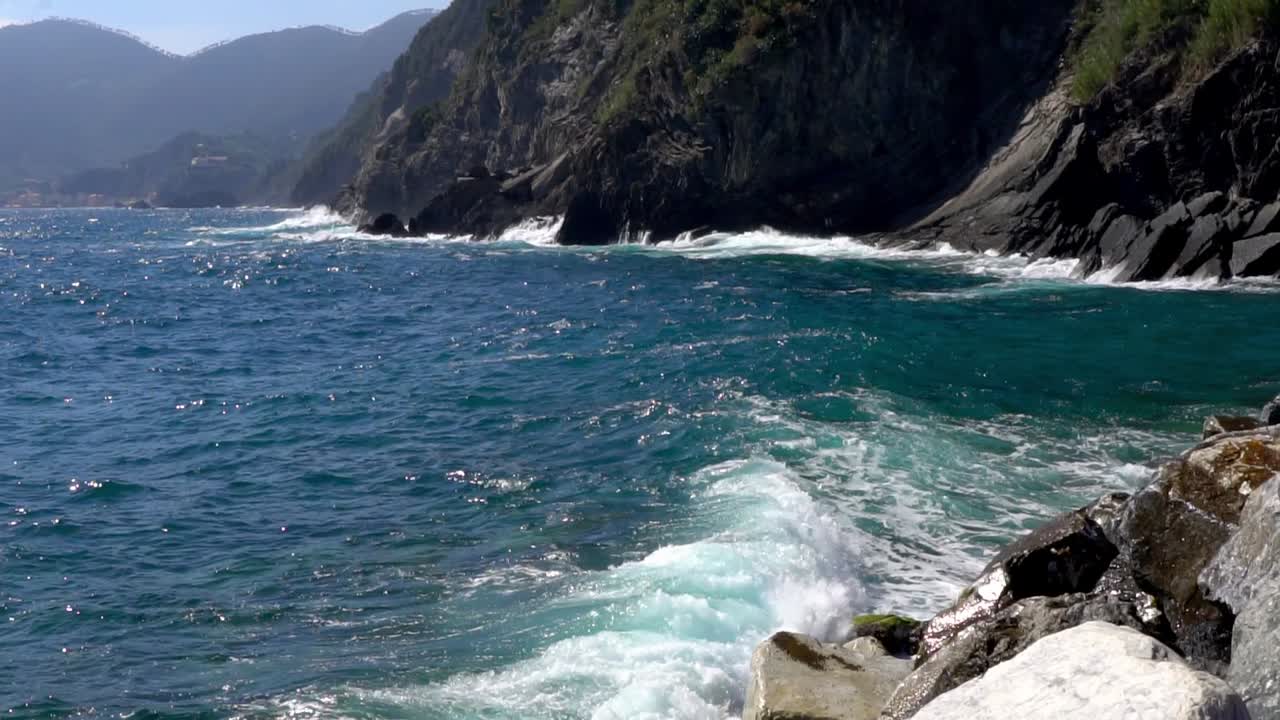 Rough Waves Breaking Against Sheer Rock Mountains In The Cinque Terre Region Of Italy. Slow Motion Shot