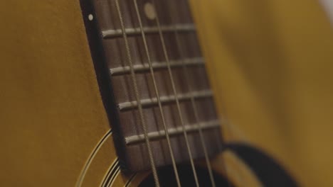 close up look at strings vibrating on a guitar