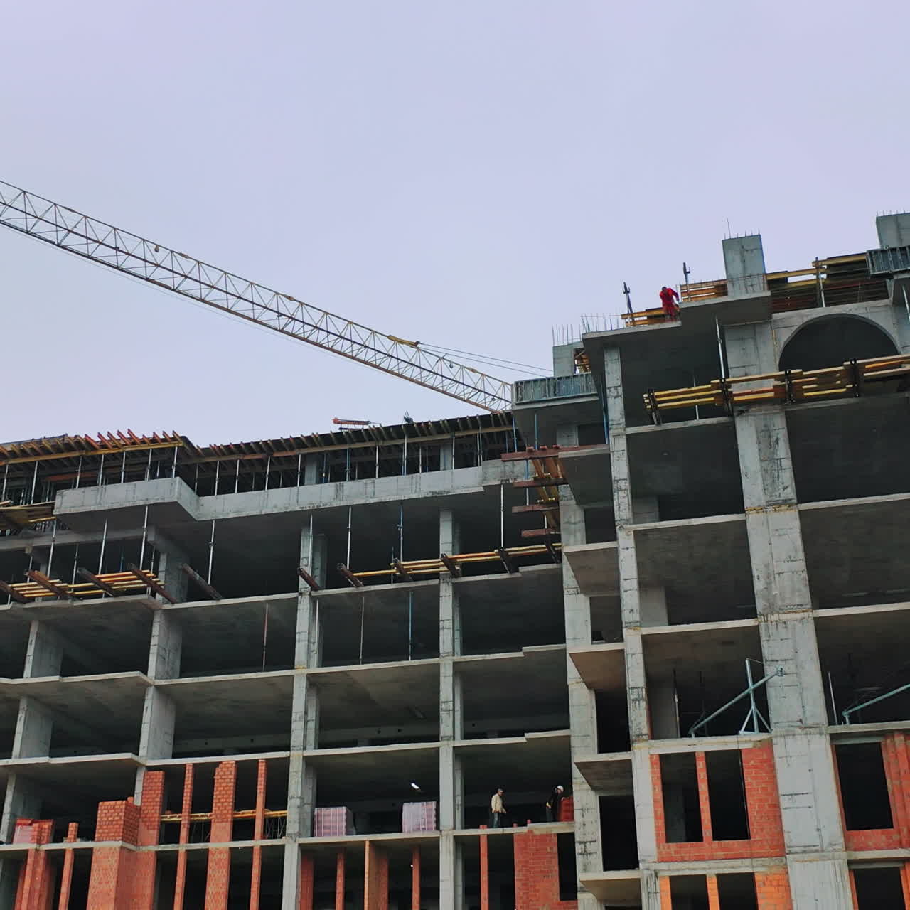 Construction of high-rise building. Front view of huge building in the process of construction. New construction site in the city.