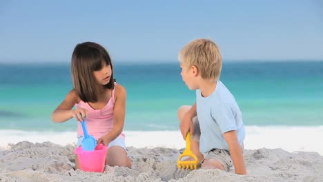 cute children building a sand castle