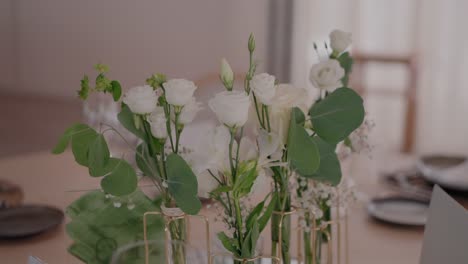 elegant white wedding centerpiece with eucalyptus and roses