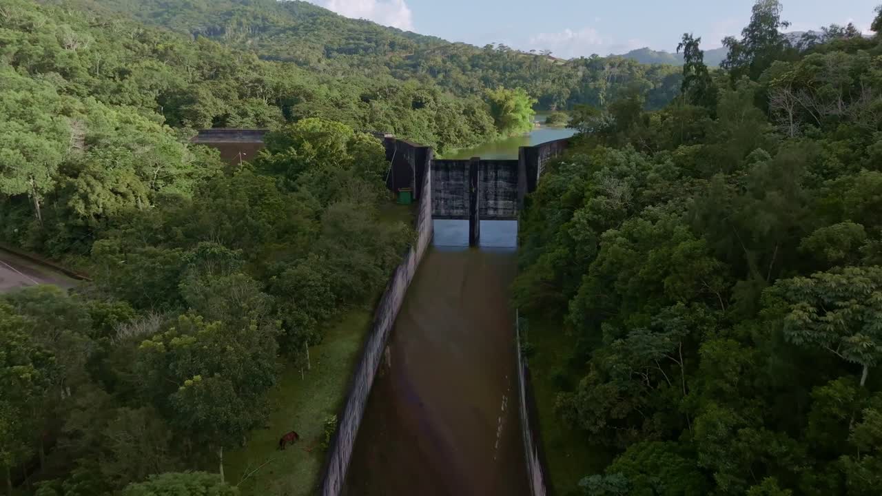Dolly in aerial shot overlooking dam walls reveal the largest water reservoir in the Caribbeans - Hatillo Dam Lake, Dominican republic