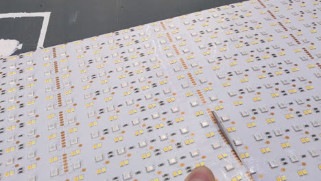 cutting led panel with scissors.