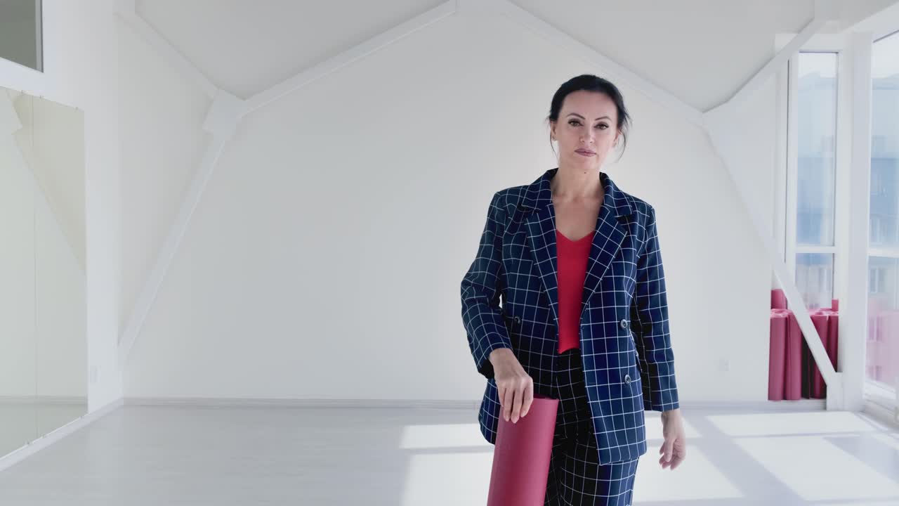 Business woman with yoga mat