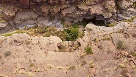 Top-down-aerial-of-dry-riverbed,-desert-like-canyon-due-to-drought