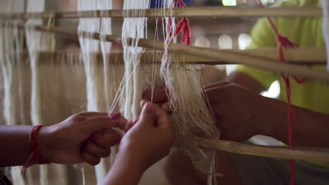 silk-cotton-close-up-skilled-hands-on-weaving-wooden-mechanical-machine