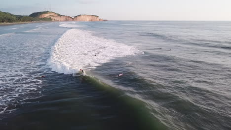 professional surfer riding perfect sea waves during summer in olon beach, ecuador