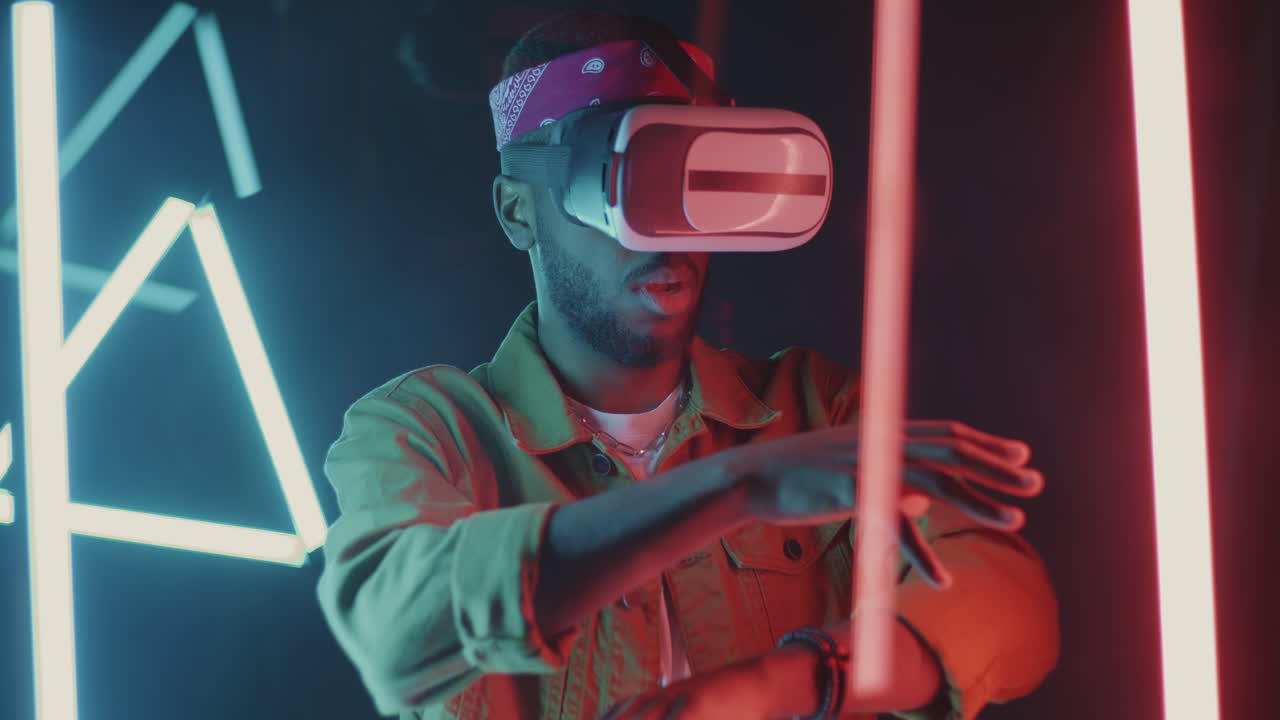 Man Experiencing Virtual Reality in a Neon Lit Environment