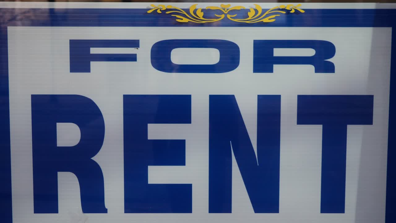 Slow reveal of a retail space for rent sign in the window of an available small business location, with “Gift Shop” on the glass, after covid 19 lockdown restrictions closed a small business.