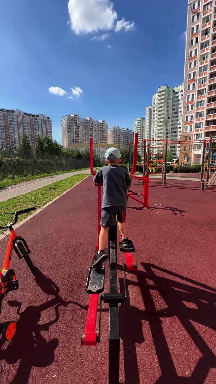 Child exercising on playground equipment outdoors