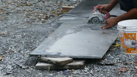 man cutting granite stone