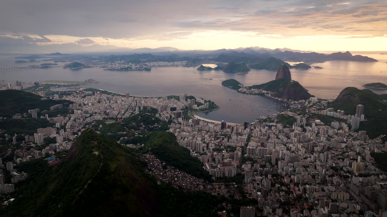 Panoramic drone view over Rio de Janeiro as sun rises over Guanabara Bay, Brazil