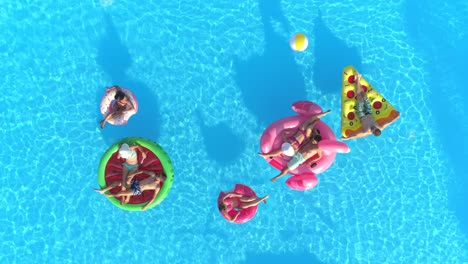 top down: a group of young friends enjoys their weekend at a fun pool party.