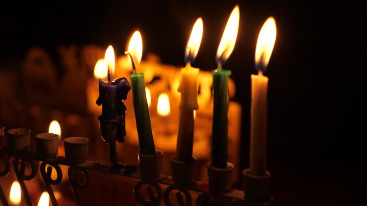 Forth night of Hanukka marked by the four lit candles and shamash in the menorah