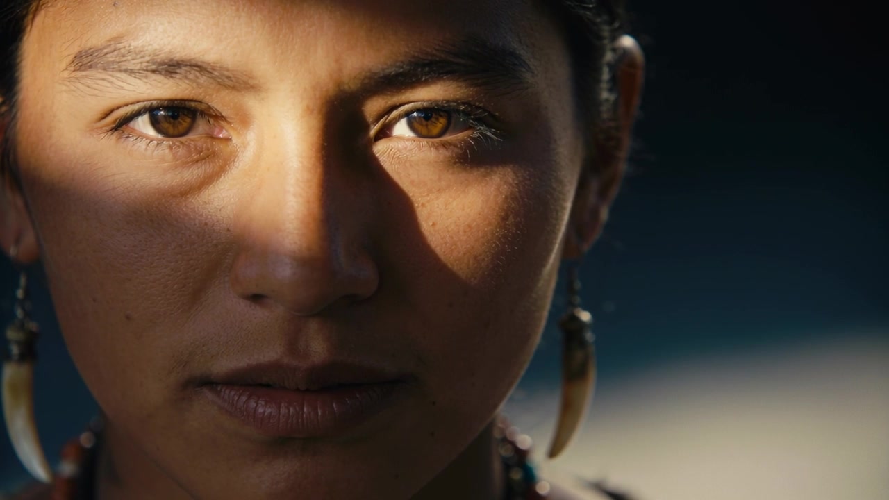 Blinking adult woman reacting to sunlight band outdoors, wearing tusk earrings and beaded strands
