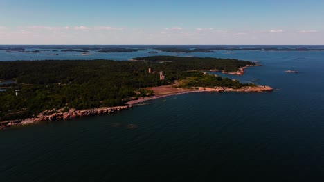 drone shot approaching the jussaro island, sunny day in uusimaa, finland