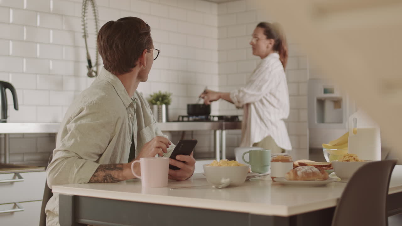 Man Using Smartphone on Breakfast