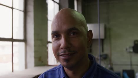 mixed race man working at a hat factory