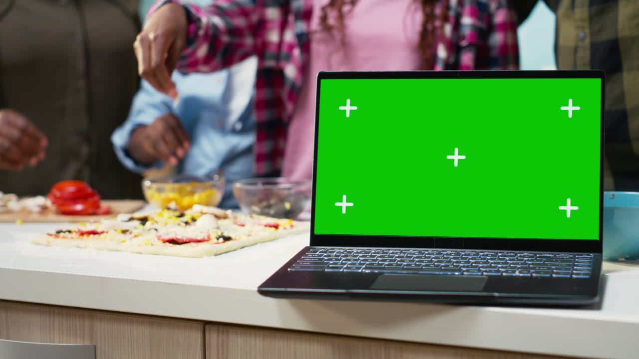 Laptop with green screen in kitchen scene