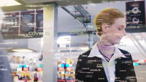animation of floating covid-19 words over caucasian airport worker during passport control