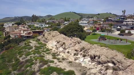 woman standing on rocks on cliff enjoying the view