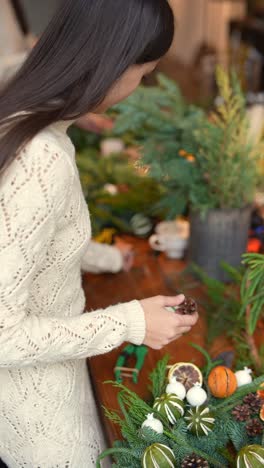 woman creating a christmas wreath