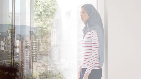 animation of cityscape over biracial woman in hijab thinking