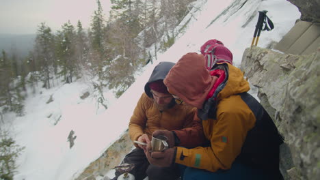 couple taking selfie at campsite in mountains