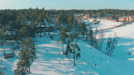 winter-resort-with-ski-tracks-on-mountains-bird-eye-view