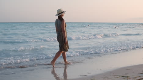 Pretty-woman-resting-at-seaside.-Barefoot-female-model-walking-in-sea-waves.