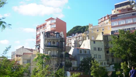 colorful houses in graca park, a bird flies past the camera