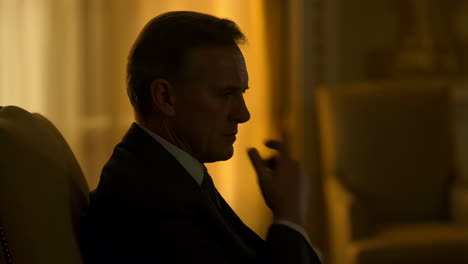 man in profile in a dimly lit room