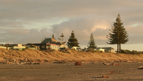 sunset over beach houses and dunes
