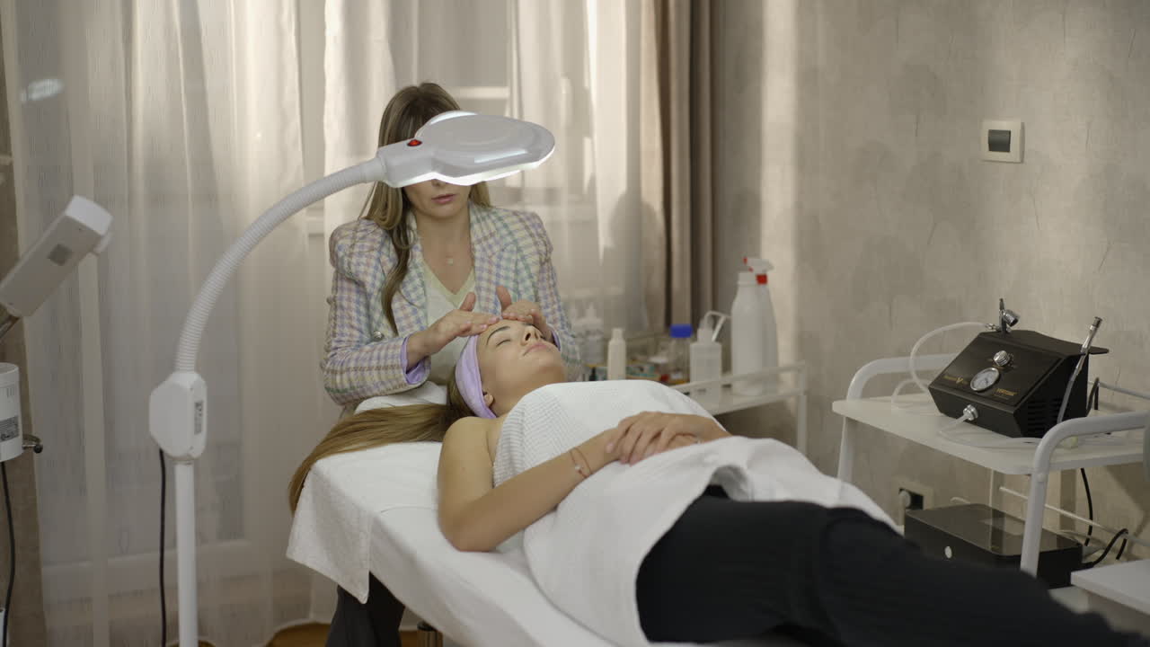 Woman Receiving a Professional Facial Treatment at a Beauty Salon