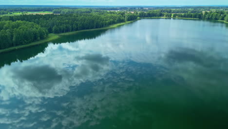 lake laukezers, latvia with the sky reflecting off the surface - aerial view