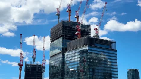 Slow-tilting-shot-showing-multiple-cranes-on-skyscrapers-at-Umekita-Underground-Station