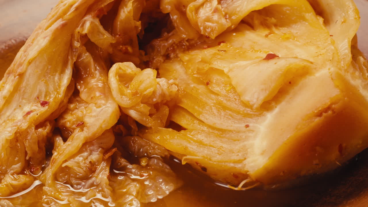 Close-up of texture fermented spicy cabbage kimchi with in can. Preservation of vegetables in glass jars. Fermentation preserved kimchi cabbage with spices macro. Asian cuisine.