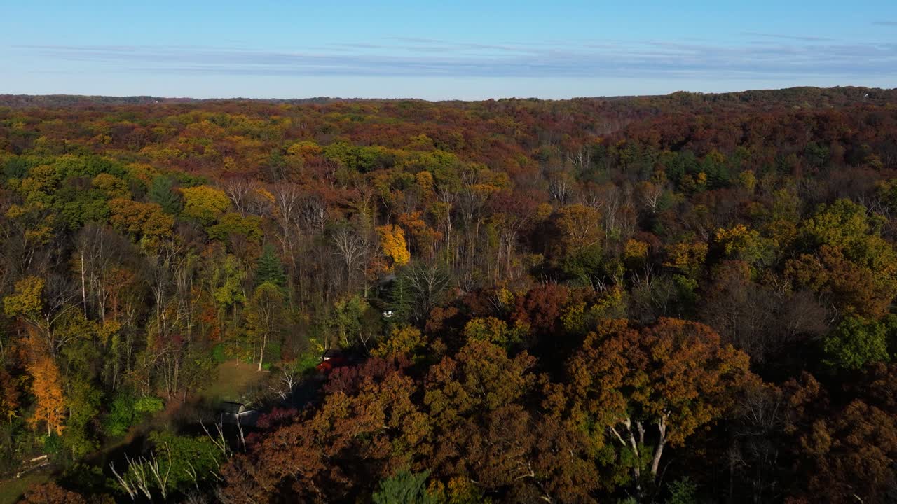 Aerial of expansive Brown County forest with rolling hills and rich autumn foliage in peak season, ascend overview