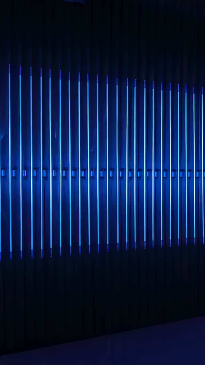Vertical video: Program starting LED array shifting angled lights across gallery, making blue wedge