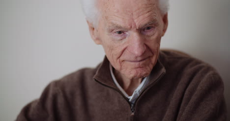 elderly senior man smiling into camera